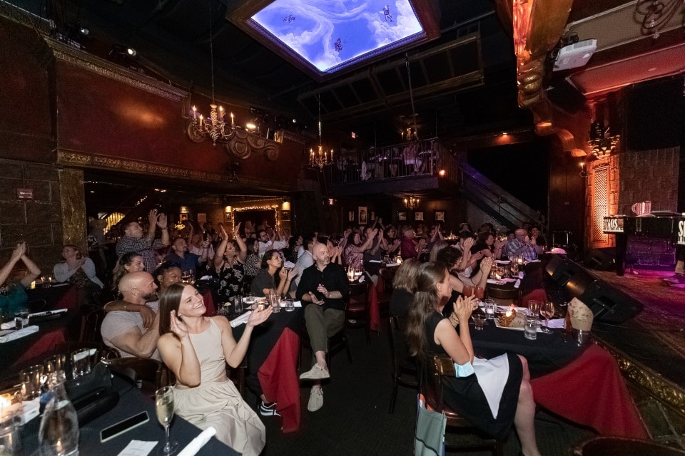 Members of the audience at a Dueling Pianos show a the Cutting Room NYC watch the show.