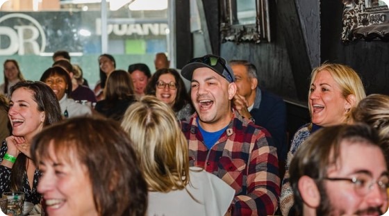 The crowd laughs along at a Boozy brunch show in New York City.