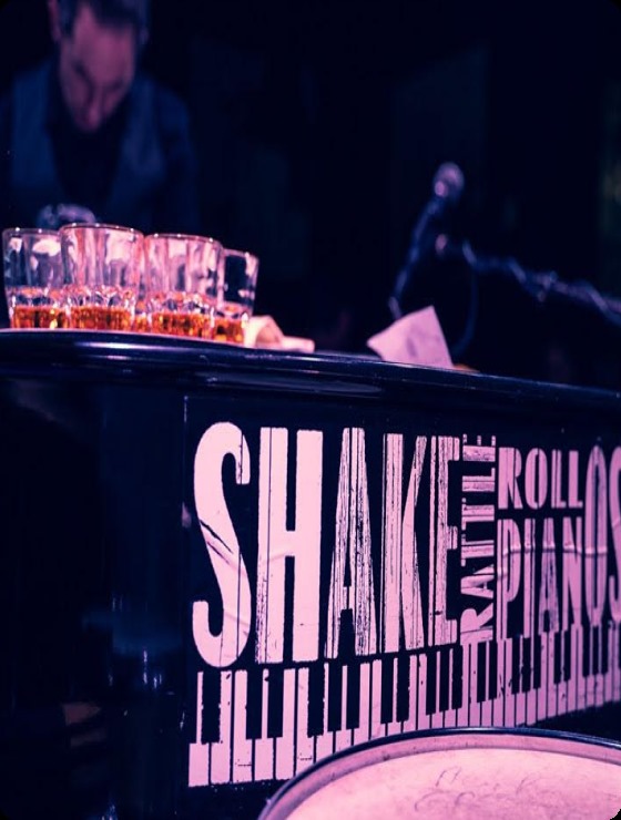 Freshly-filled shot glasses on the piano at a Saturday night show.