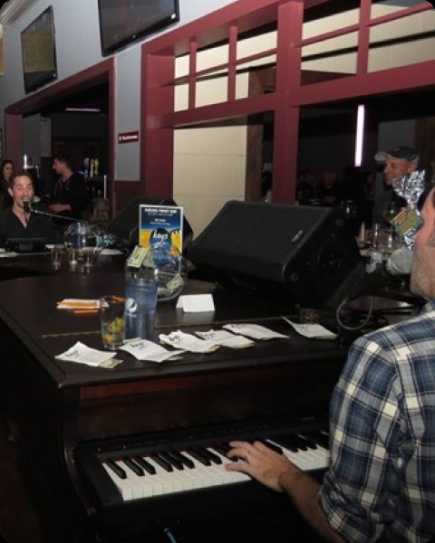 Dueling pianists at a bar show.