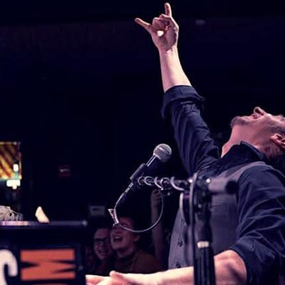 Pianist Mark Weiser playing a lively rock song at a Saturday night dueling pianos show, live in New York City.